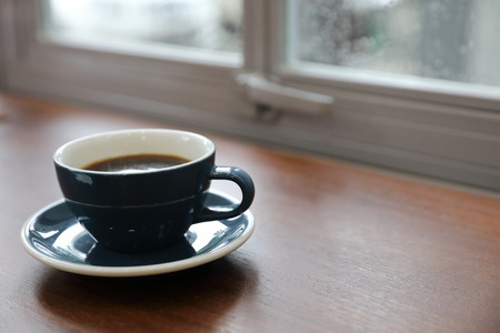 Black coffee in Coffee cup on wood backgroundの写真素材