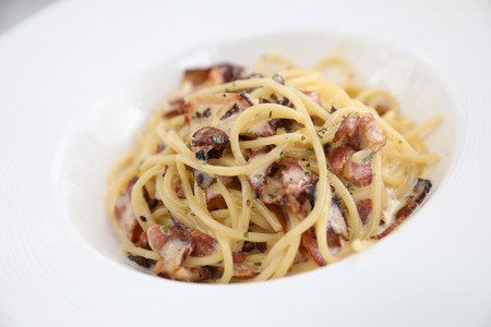 Spaghetti carbonara , Spaghetti white sauce with cheese bacon in outdoor restaurant italian foodの写真素材