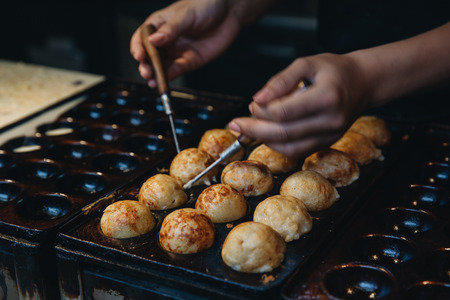 Woman hand making Takoyaki , Japanese street foodの写真素材