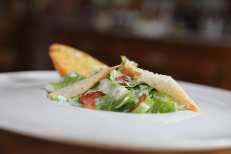 fresh salad with bacon and bread on wooden backgroundの写真素材