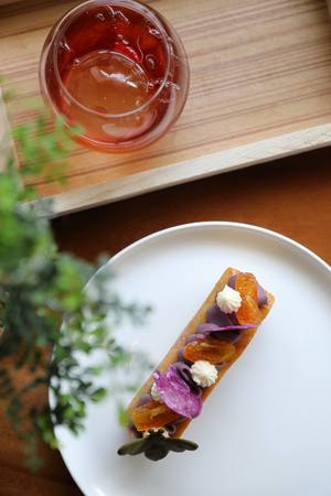 Sweet homemade fance peach cake on wooden table