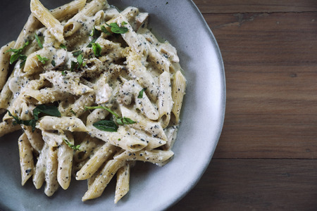 Penne pasta with white sauce and truffle , italian food