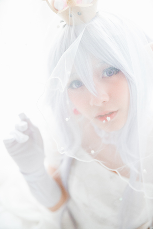 Portrait of vampire dracula young woman dress in white tone room halloween conceptの写真素材