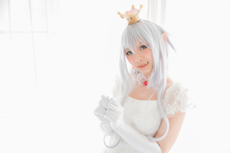 Portrait of vampire dracula young woman dress in white tone room halloween conceptの写真素材