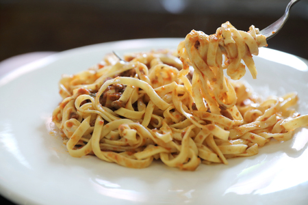 spaghetti Bolognese with minced beef and tomato sauce garnished with parmesan cheese and basil , Italian foodの写真素材