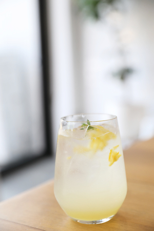 Lemonade or mojito cocktail with lemon and mint, cold refreshing drink or beverage with iceの写真素材
