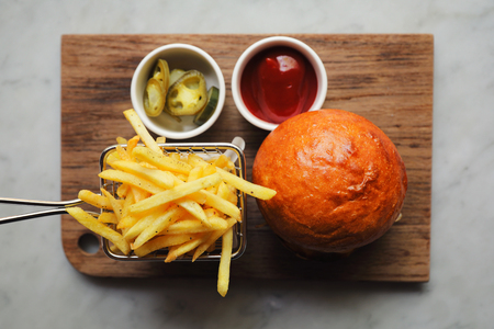 Beef Hamburger with fries and ketchup on wood bard , fast food