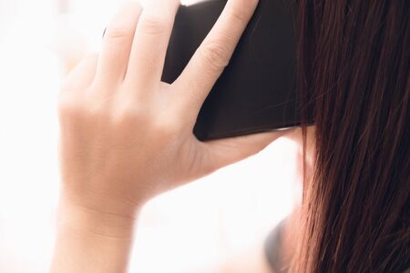 Woman hand calling with smartphone in business