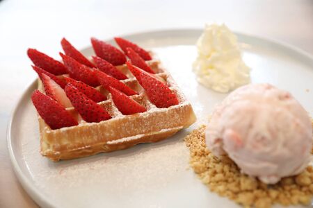 Strawberry waffle with ice cream , dessert on wood background