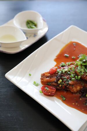 Fried fish with spicy sauce and rice , traditional thai foodの写真素材
