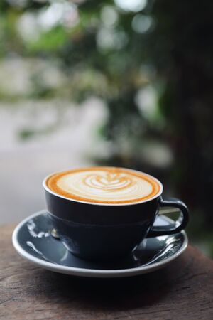 cappuccino or Latte art coffee made from milk on the wood table in coffee shopの写真素材