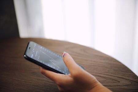 Woman hand using smart phone in businessの写真素材