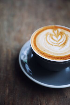cappuccino or Latte art coffee made from milk on the wood table in coffee shopの写真素材