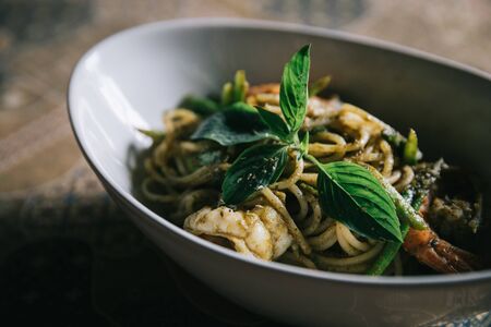 Pesto Spaghetti with shimp in high contrast italian foodの写真素材