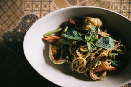 Pesto Spaghetti with shimp in high contrast italian food
