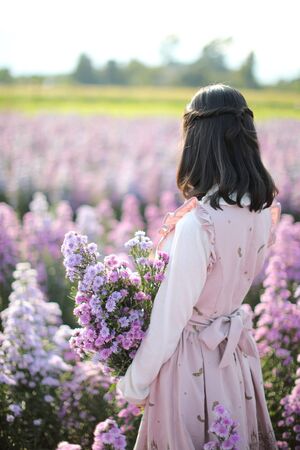 Portrait asian girl with purple flowers background