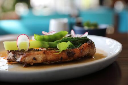 Grilled Porkchop and vegetables on top on wood background