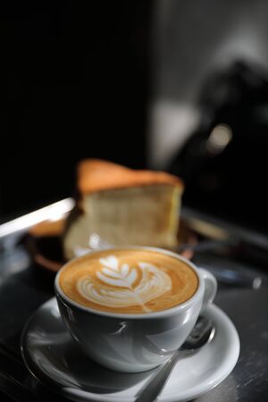 Hot cappuccino or Latte art coffee made from milk on the wood table in coffee shopの写真素材