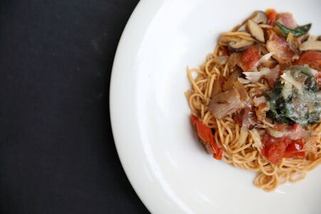 spaghetti Bolognese with minced beef and tomato sauce garnished with parmesan cheese and basil ,...
