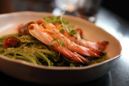 spaghetti pesto sauce with grilled shrimps italian food