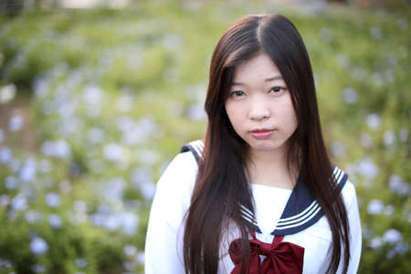 school girl costume at park outdoor with flowers garden background
