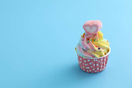 Colorful cupcake isolated in blue backgroundの写真素材