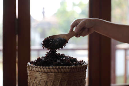 Boiled riceberry rice on Wicker basket with spoon in close upの写真素材