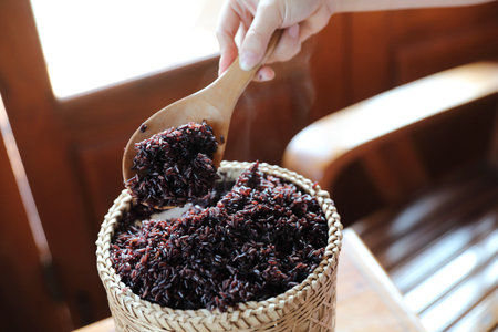 Boiled riceberry rice on Wicker basket with spoon in close upの写真素材