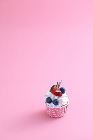 Fruits cupcake isolated in pink backgroundの写真素材