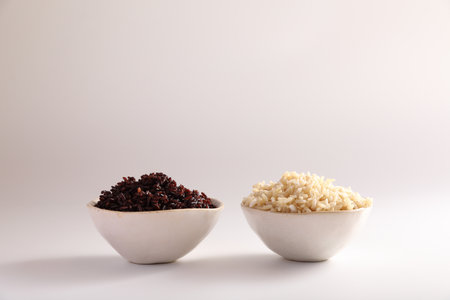 Organic boiled brown rice on bowl isolated in white backgroundの写真素材