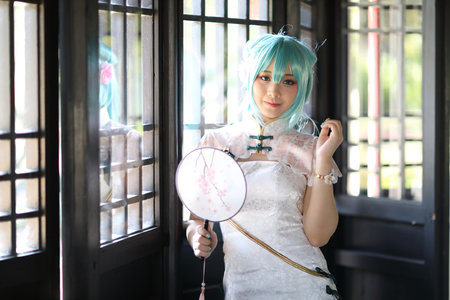Japan anime cosplay portrait of a girl with chinese dress costume in chinese garden