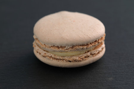 Colorful macarons isolated in black backgroundの写真素材