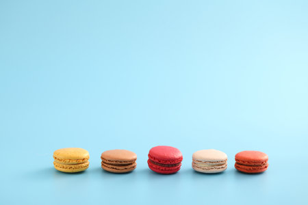 Colorful macarons isolated in blue backgroundの写真素材