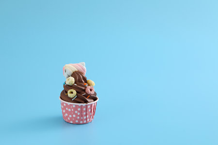 Chocolate cupcake isolated in blue backgroundの写真素材