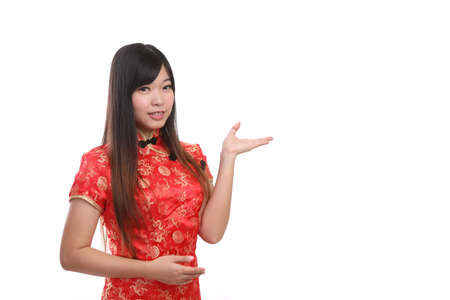 beauty woman wear red cheongsam looking and smile in chinese new year isolated white backgroundの写真素材