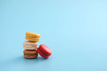 Colorful macarons isolated in blue backgroundの写真素材