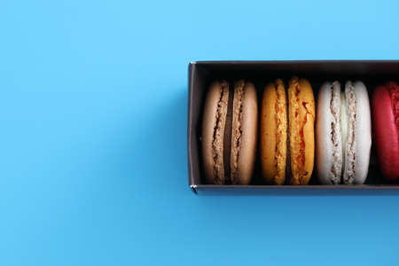 Colorful macarons isolated in blue backgroundの写真素材