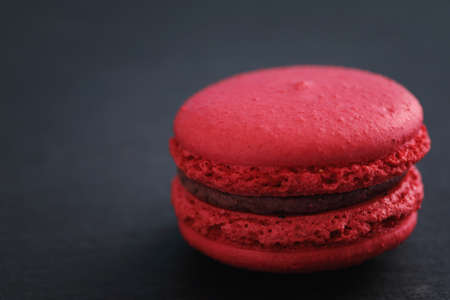 Colorful macarons isolated in black backgroundの写真素材
