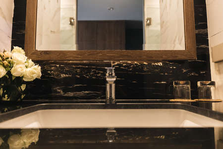 Basin in luxury bathroom with rose flowerの写真素材