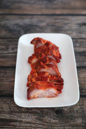 Roasted pork thai local food with red sauce on wood backgroundの写真素材