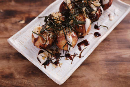 Takoyaki isolated in wood background Japanese foodの写真素材