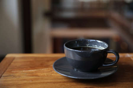 Coffee cup on wood table in local coffee shopの写真素材