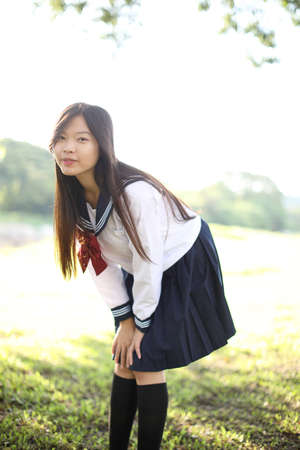 Asian school girl with countryside backgroundの写真素材