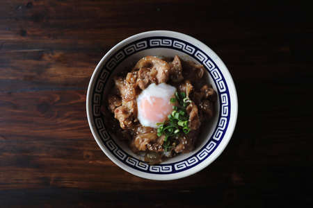pork rice bowl with egg on wood backround japanese local food butadonの写真素材