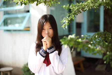 Japanese school girl in local coffee shopの写真素材