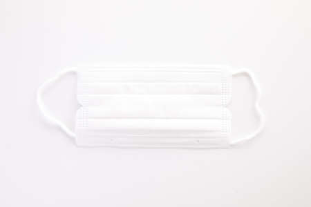 Used white mask isolated in white backgroundの写真素材