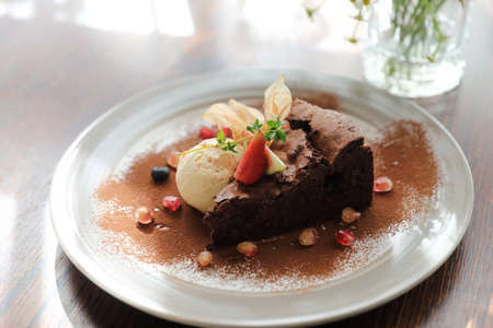 Chocolate cake with ice cream dessert on wood tableの写真素材