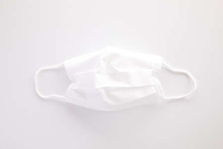 Used white mask isolated in white backgroundの写真素材