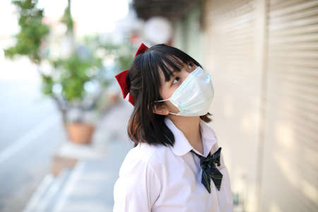 Portrait school girl with maskの写真素材