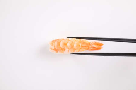Shrimp sushi with chopsticks Japanese food isolated in white backgroundの写真素材